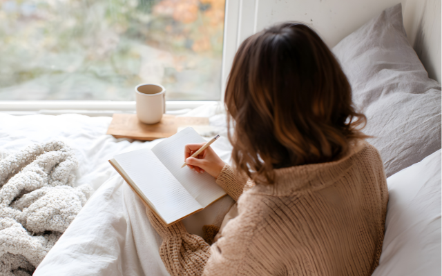 Woman writing self-reflection journal